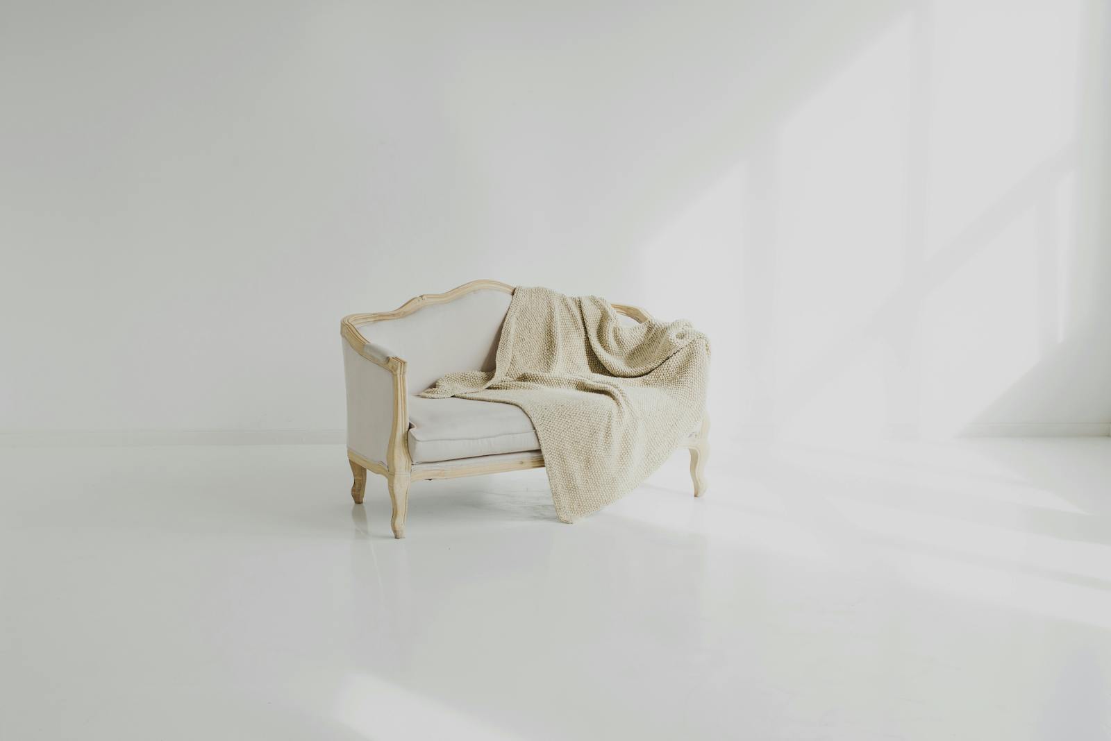 White Towel on White Wooden Sofa