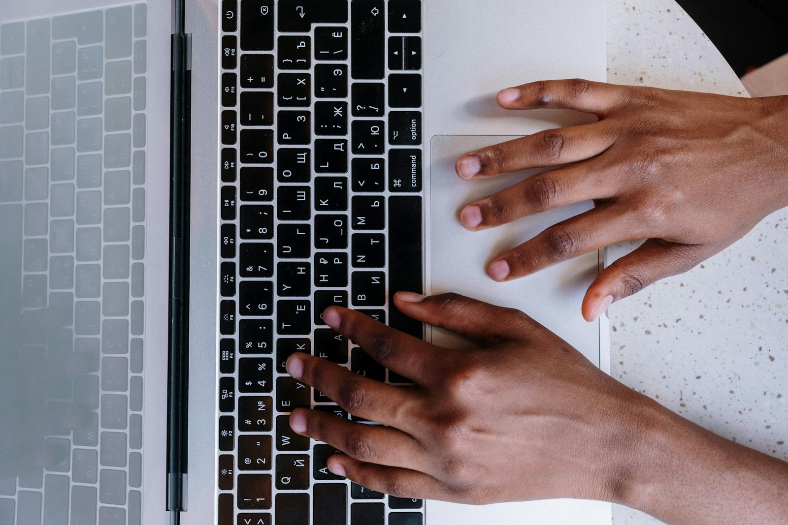 Persons Hand on Macbook Pro